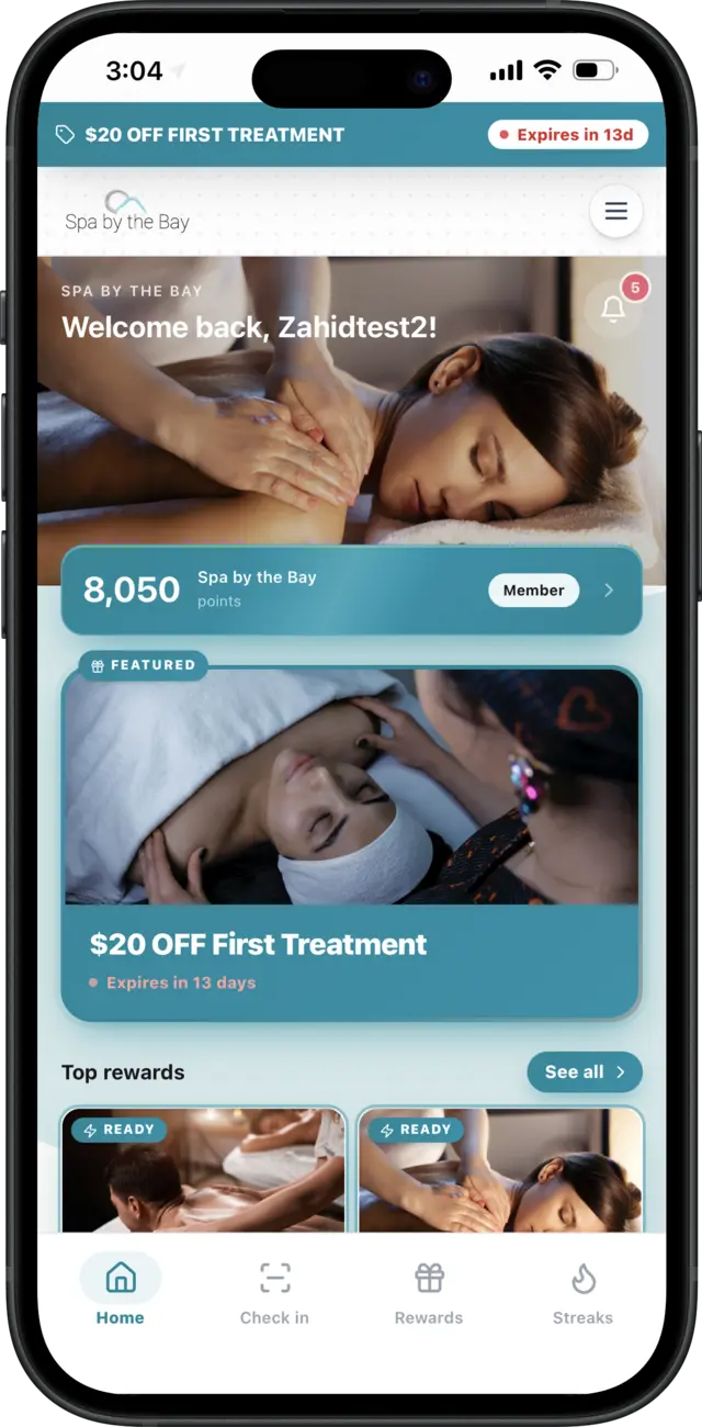 Spa by the Bay rewards app on an iPhone — teal-branded home screen with a first treatment offer
