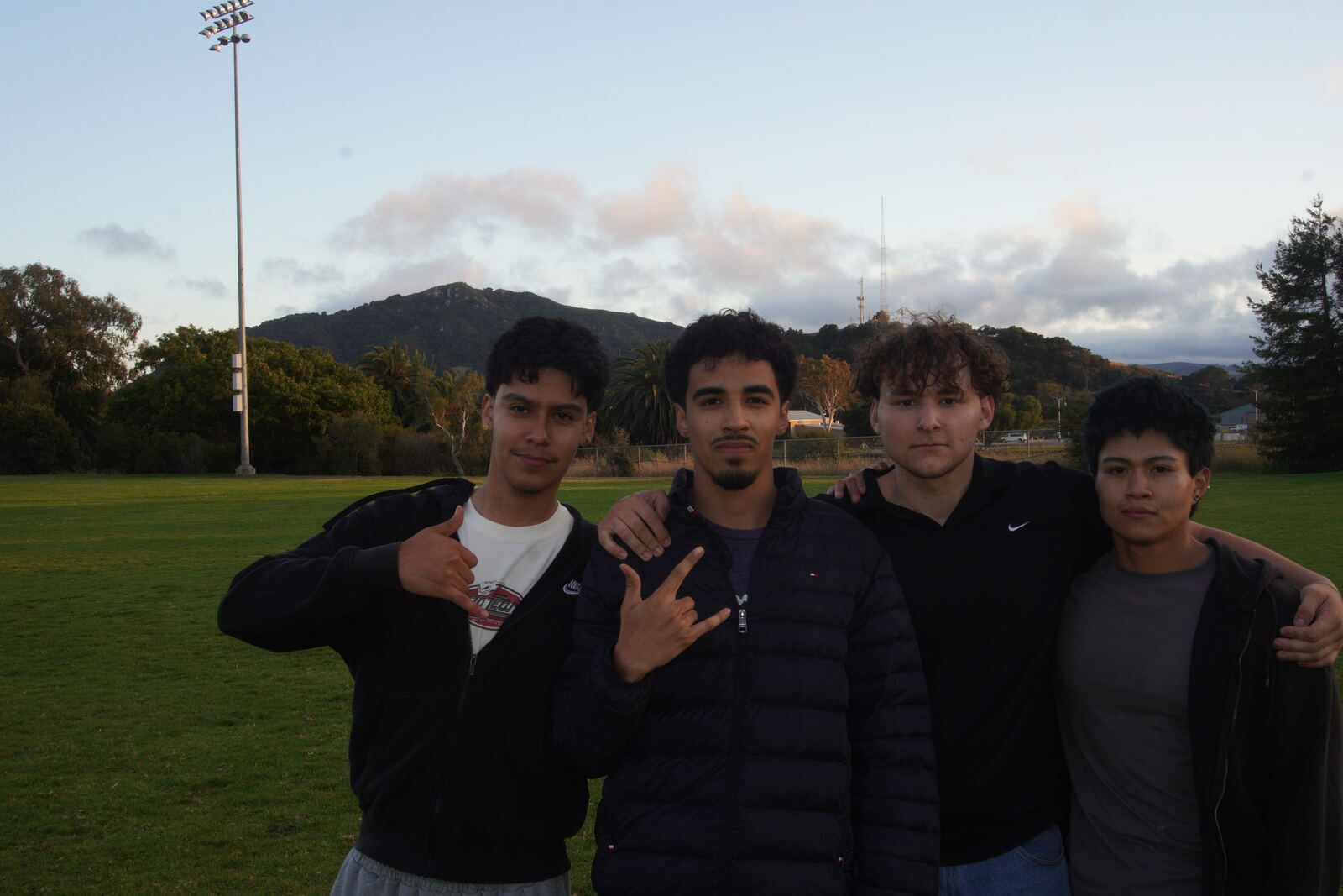 The Atlas Engine team on a field at sunset